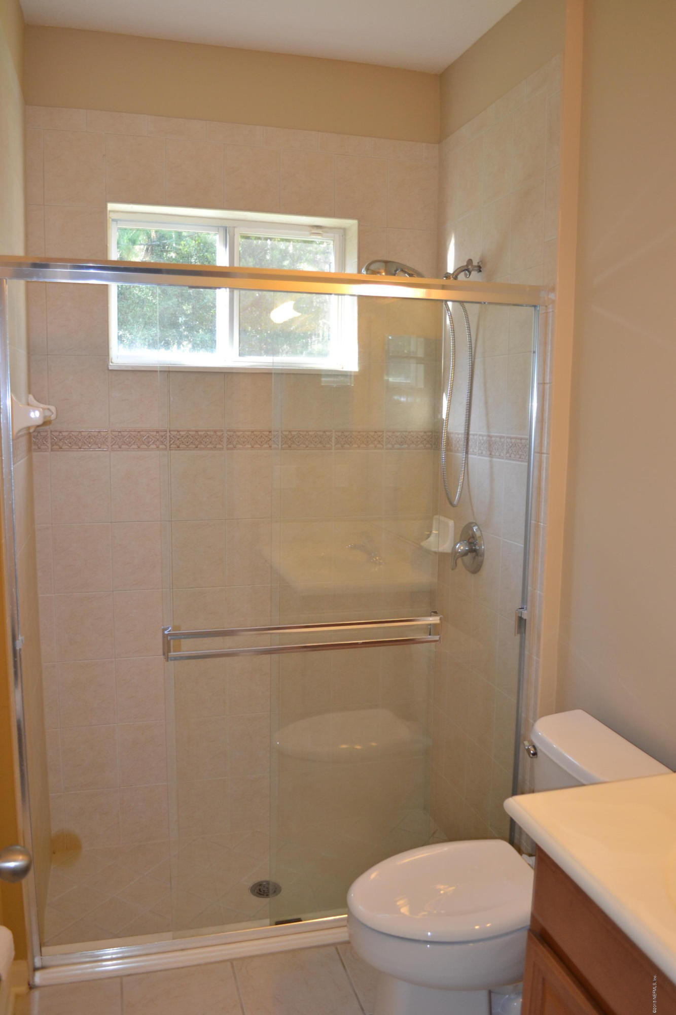 14422 Millhopper Road Jacksonville, FL 32258 - Photo 38 of 65 a bathroom with a granite countertop toilet a sink and a mirror