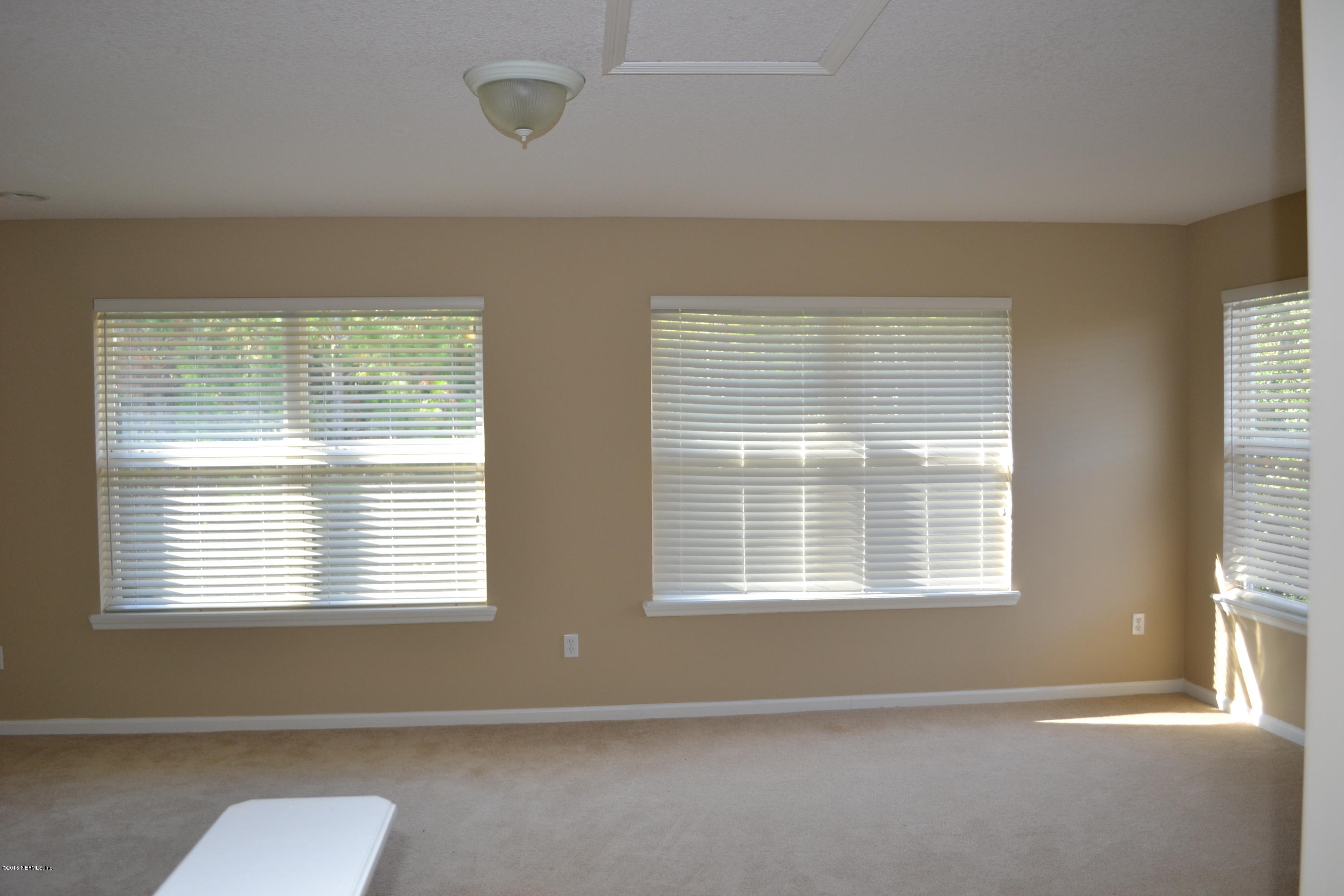 14422 Millhopper Road Jacksonville, FL 32258 - Photo 41 of 65 a view of an empty room with a window