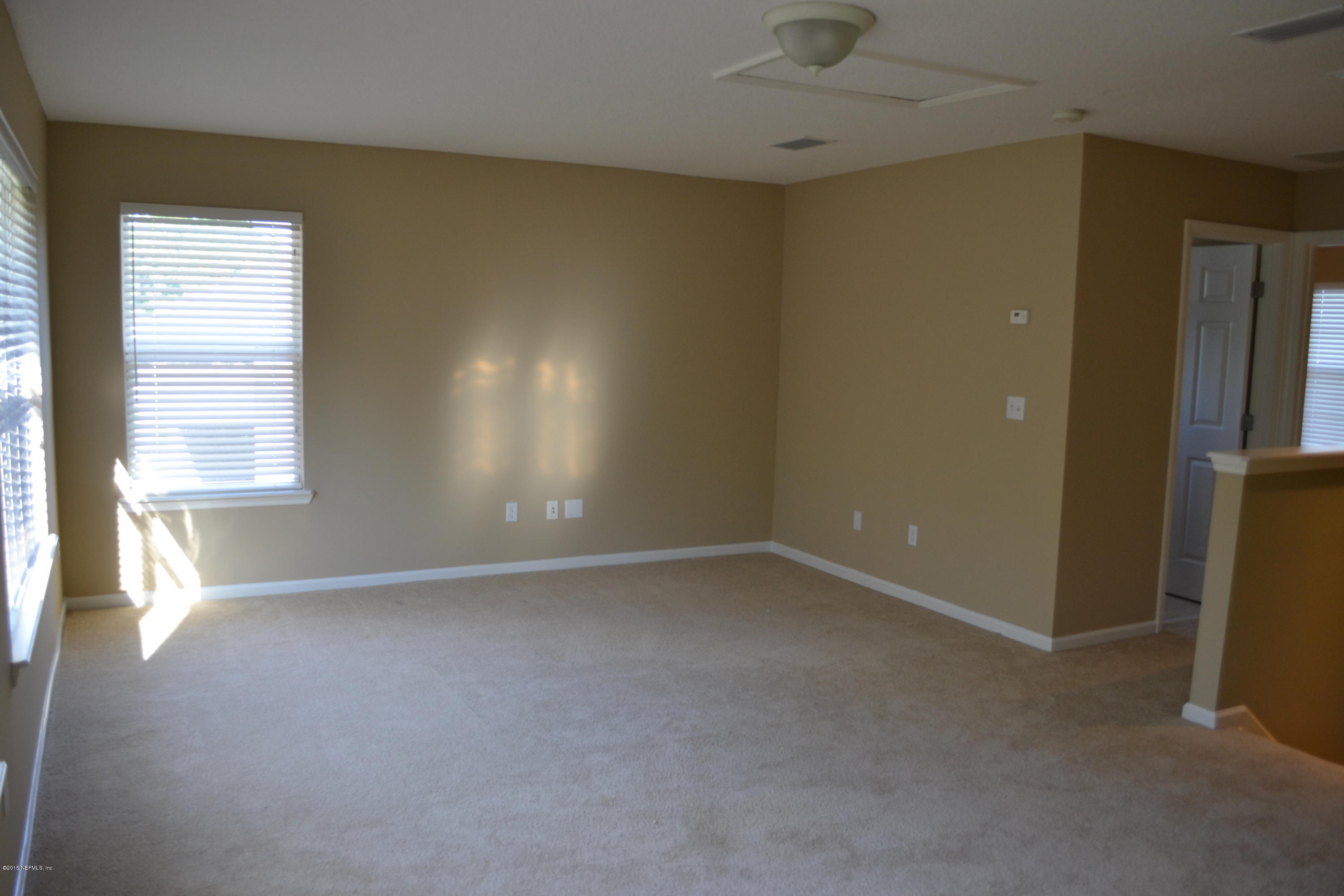 14422 Millhopper Road Jacksonville, FL 32258 - Photo 42 of 65 an empty room with windows