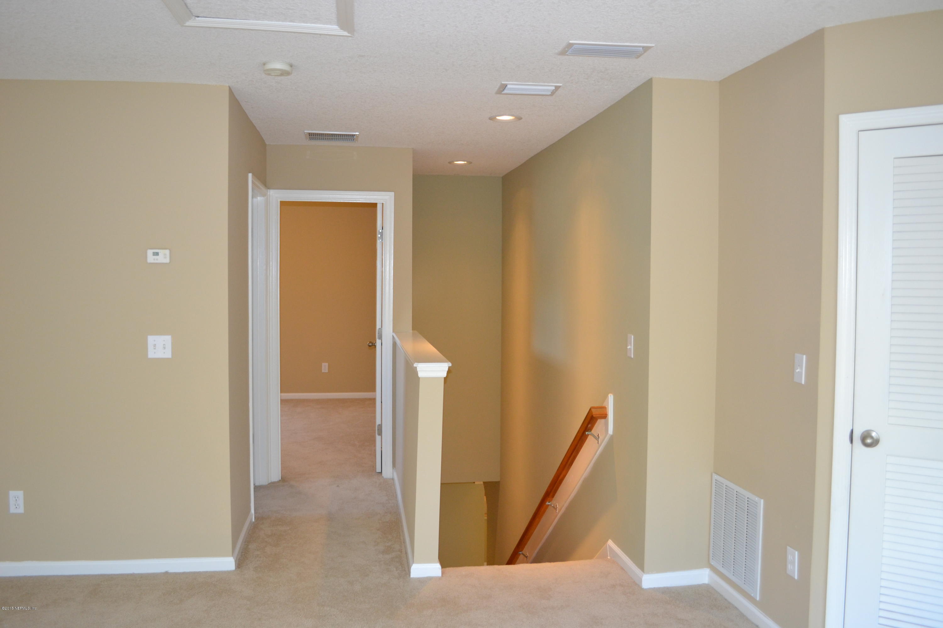 14422 Millhopper Road Jacksonville, FL 32258 - Photo 43 of 65 a view of a hallway with space and mirrors