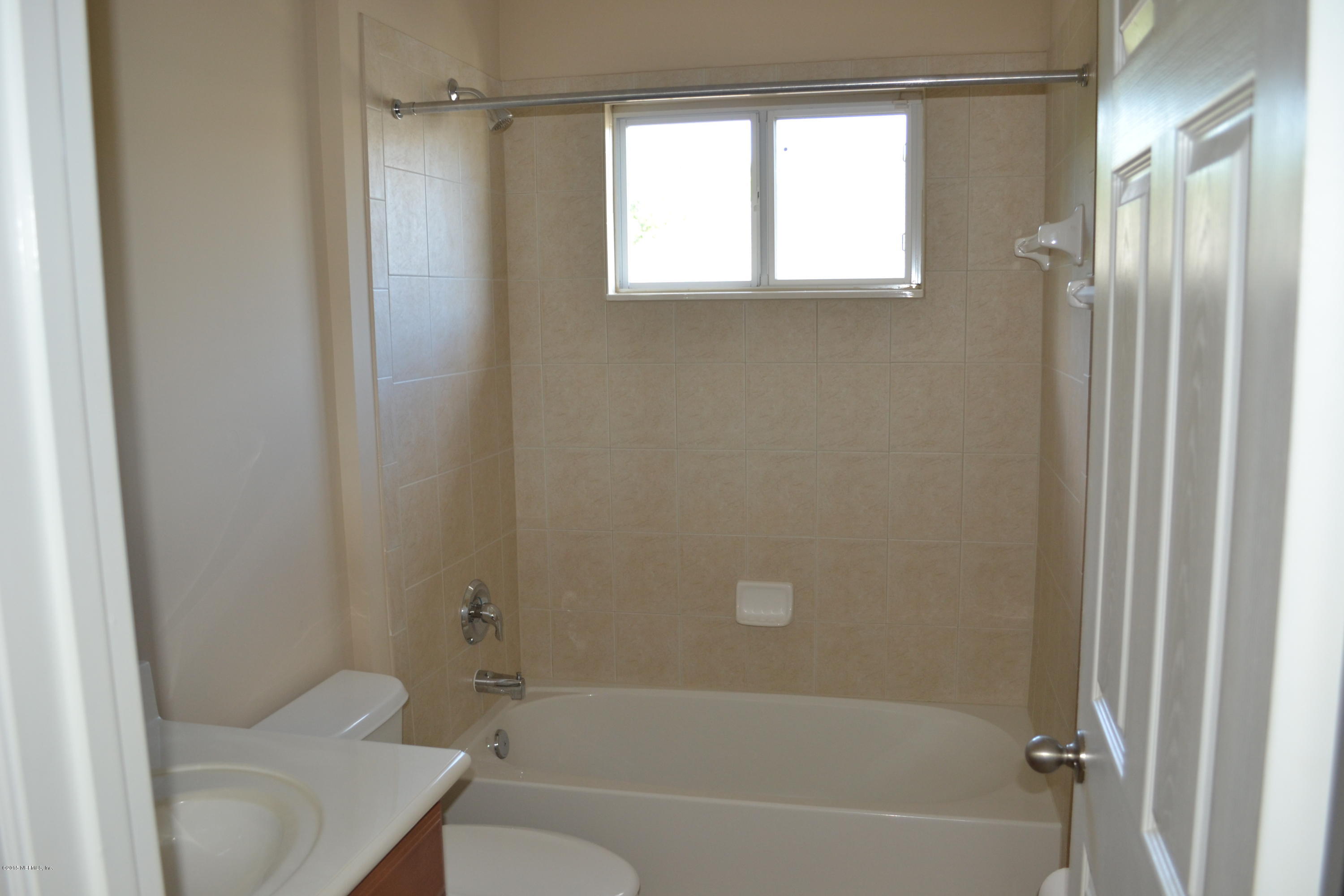 14422 Millhopper Road Jacksonville, FL 32258 - Photo 44 of 65 a bathroom with a sink toilet and shower