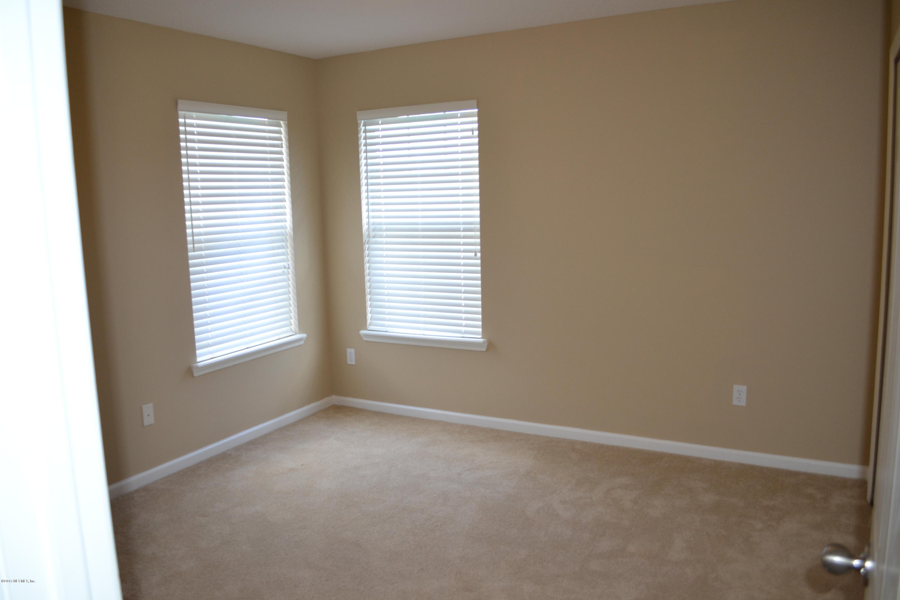 14422 Millhopper Road Jacksonville, FL 32258 - Photo 45 of 65 an empty room with windows