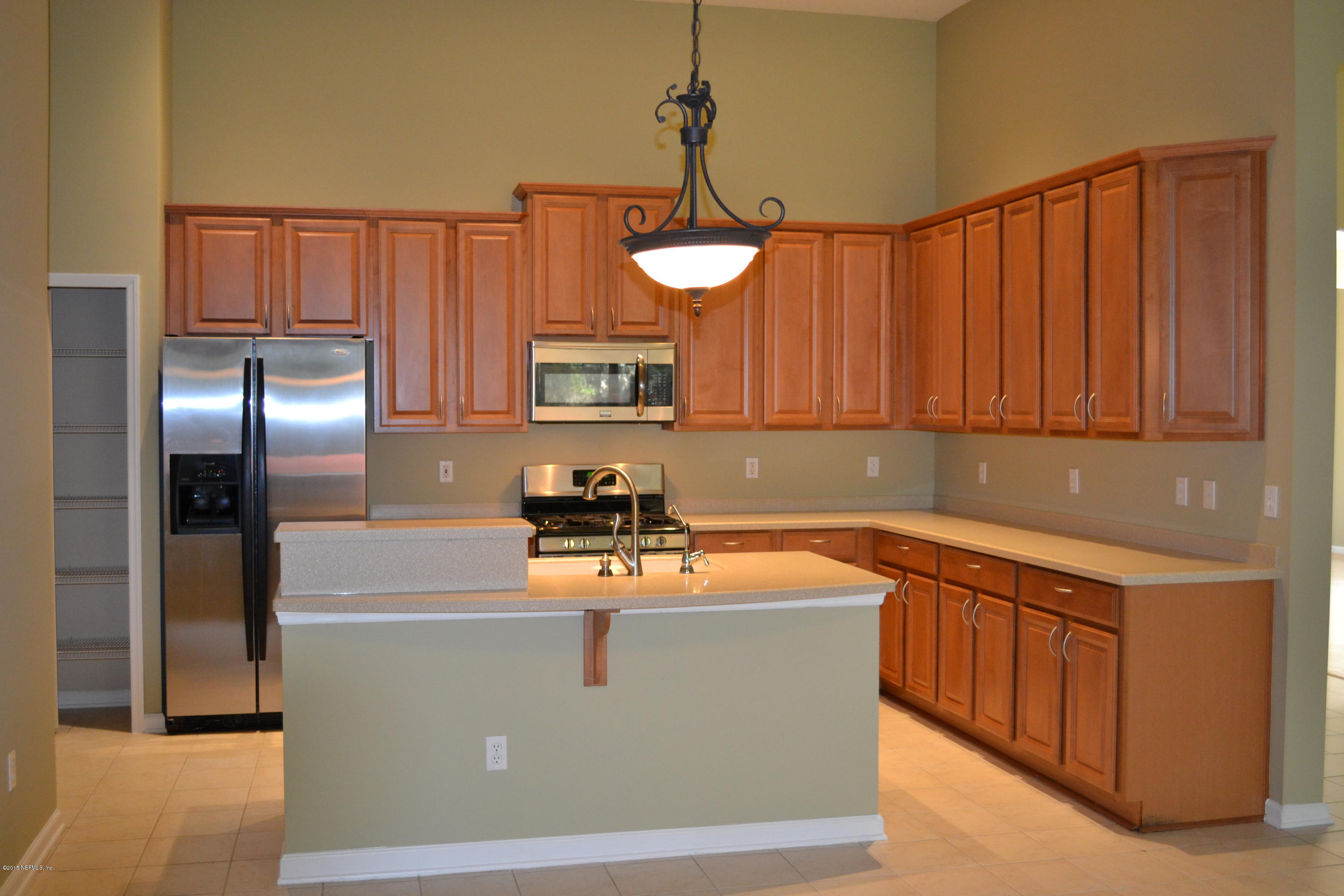14422 Millhopper Road Jacksonville, FL 32258 - Photo 54 of 65 a room with stainless steel appliances granite countertop a refrigerator a sink dishwasher a stove top oven a washer and dryer