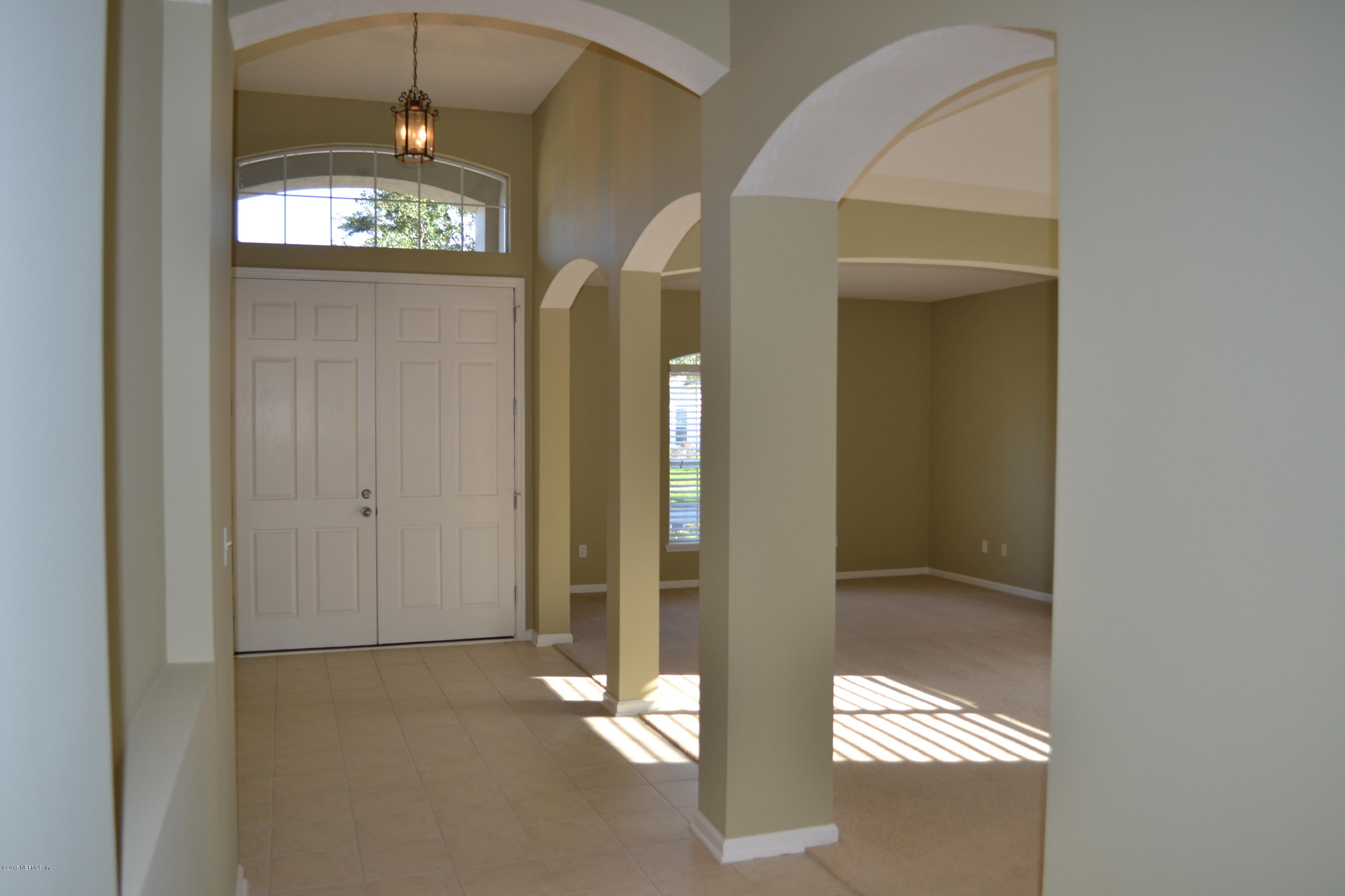 14422 Millhopper Road Jacksonville, FL 32258 - Photo 8 of 65 a view of a hallway with wooden floor