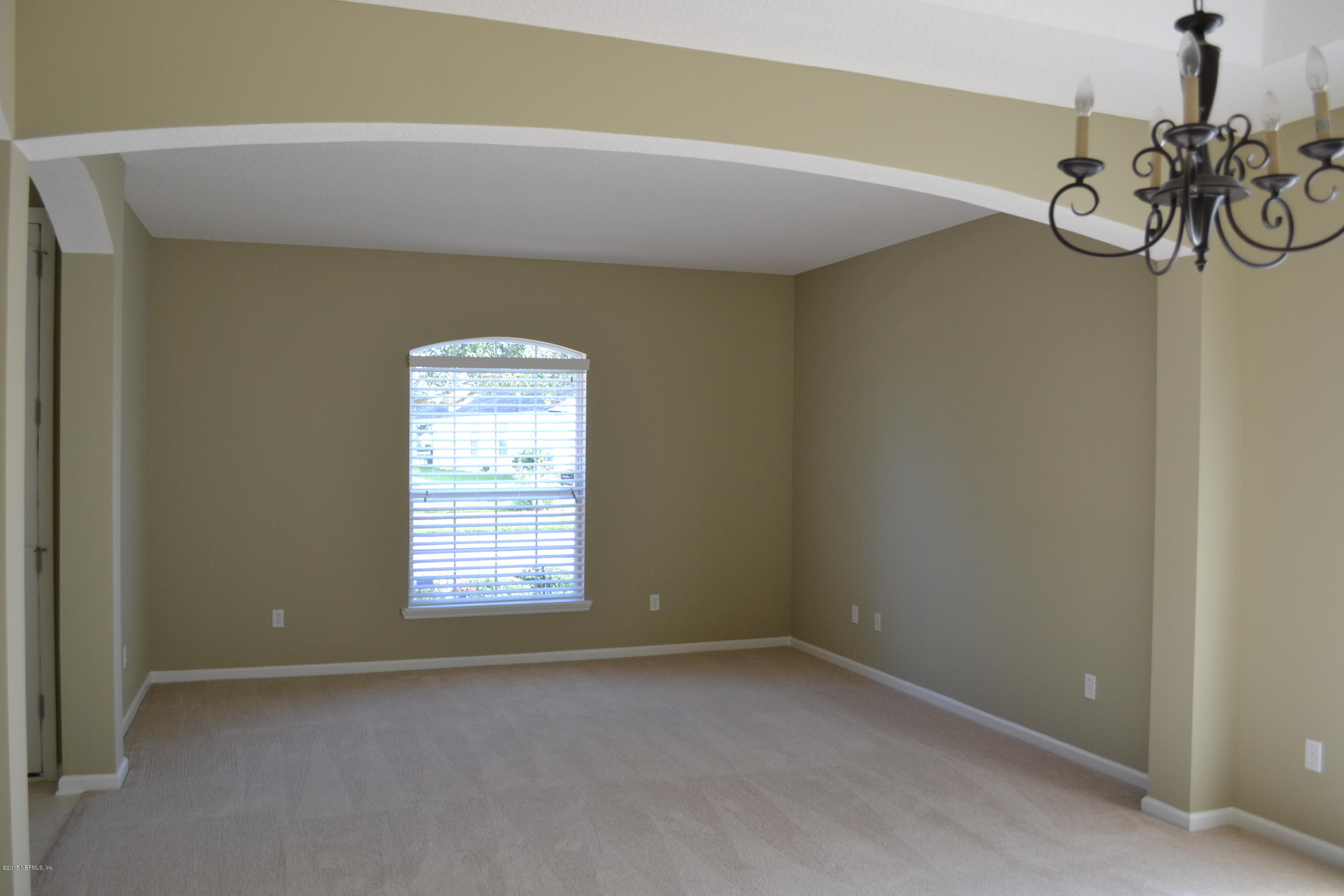 14422 Millhopper Road Jacksonville, FL 32258 - Photo 9 of 65 a view of a room with windows and chandelier