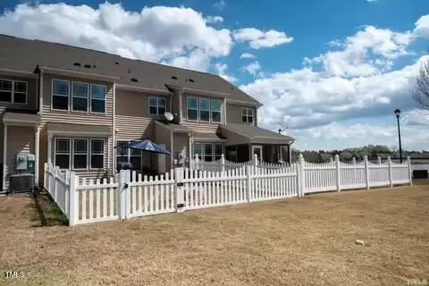 a front view of a house with a fence