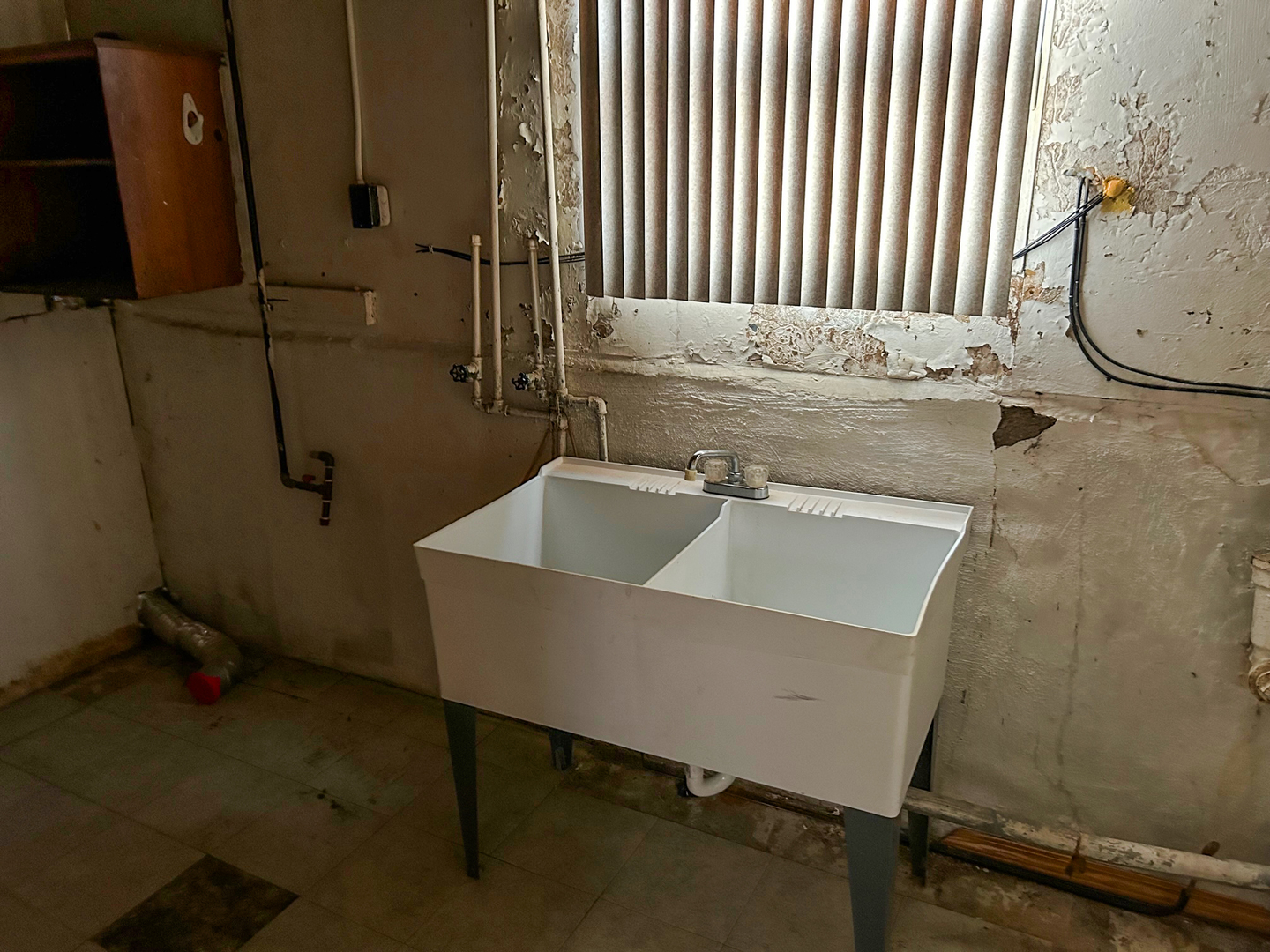 12919 South Escanaba Avenue Chicago, IL 60633 - Photo 15 of 16 a bathroom with a sink and a mirror