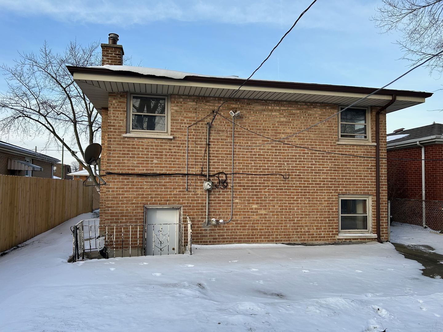 12919 South Escanaba Avenue Chicago, IL 60633 - Photo 4 of 16 a front view of a house with a yard