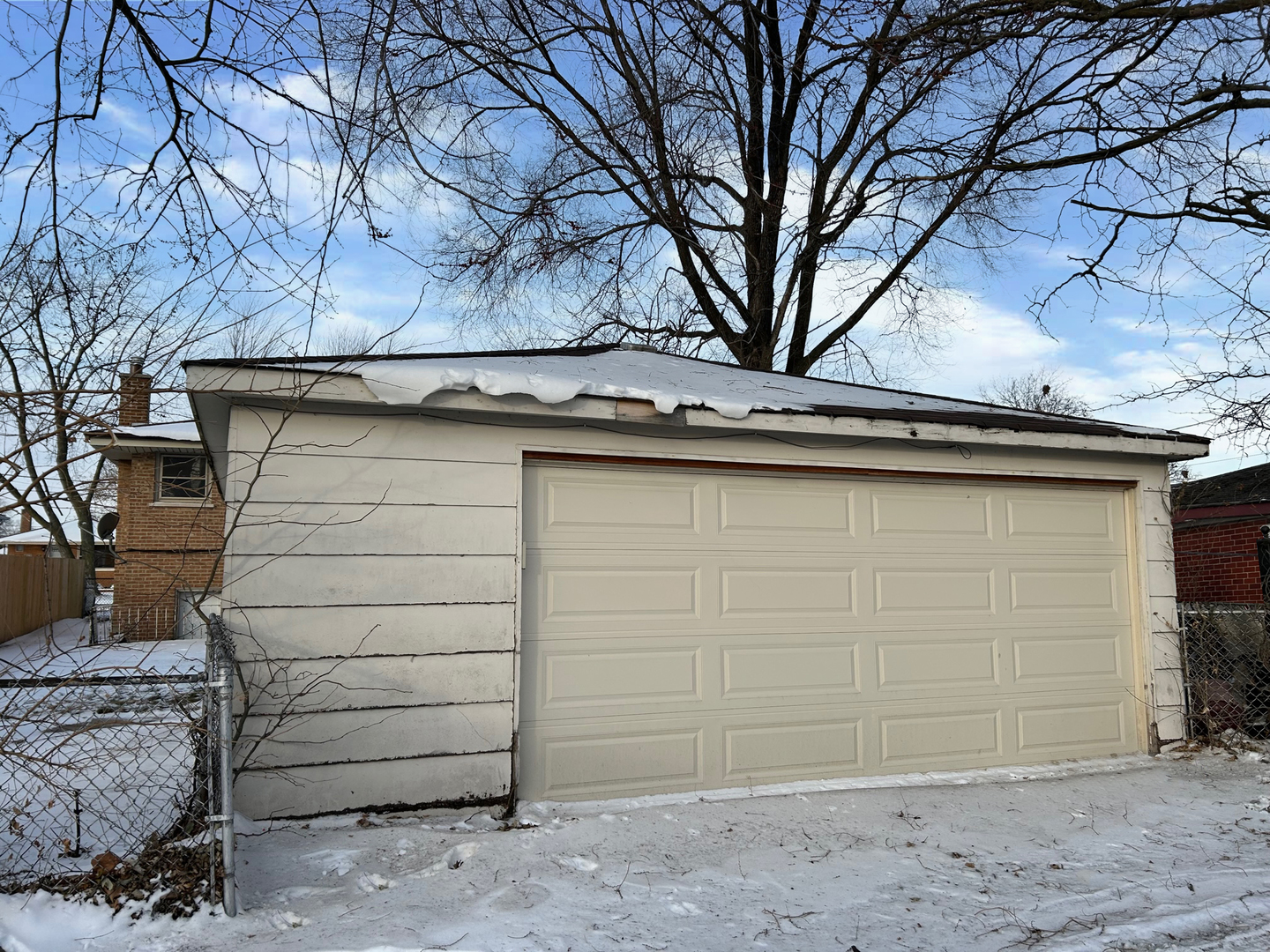 12919 South Escanaba Avenue Chicago, IL 60633 - Photo 6 of 16 a view of a house with a large tree