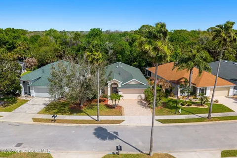 an aerial view of a house with garden space and lake view