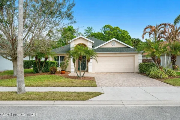 an aerial view of a house with garden space and lake view