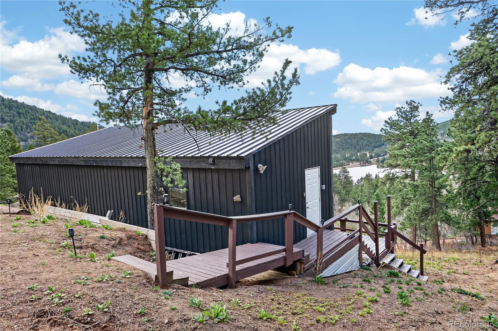161 Highland Circle Rye, CO 81069 - Photo 13 of 26 a view of a house with a yard and wooden fence