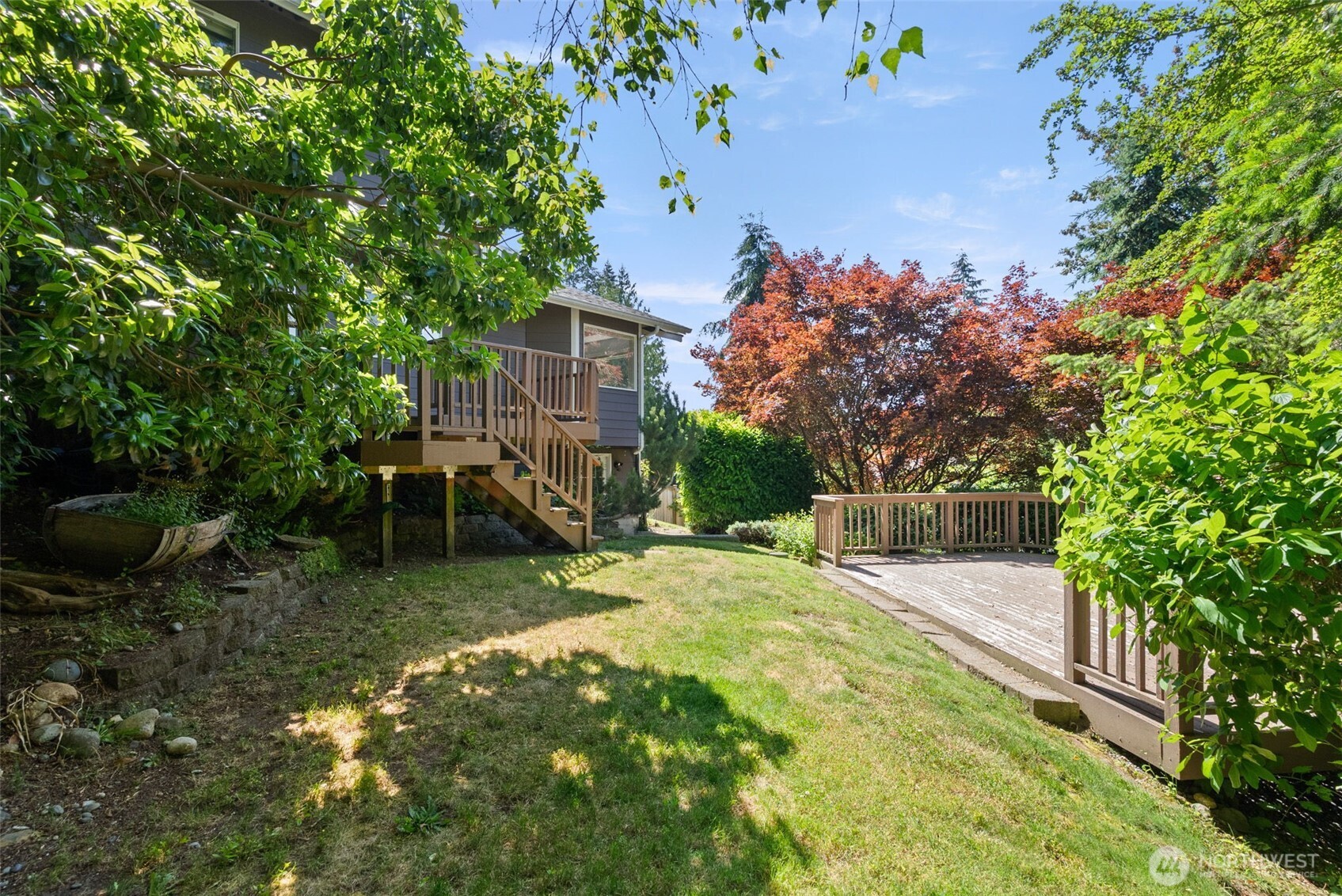 26227 Montera Loop Northeast Kingston, WA 98346 - Photo 22 of 22 a view of backyard with a table and chairs and potted plants