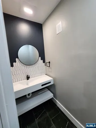 a room with a chair and a mirror