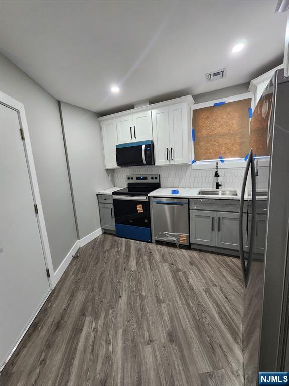 93 Hughes Street, Unit 2 Maplewood, NJ 07040 - Photo 5 of 16 a kitchen with stainless steel appliances granite countertop a sink stove and refrigerator