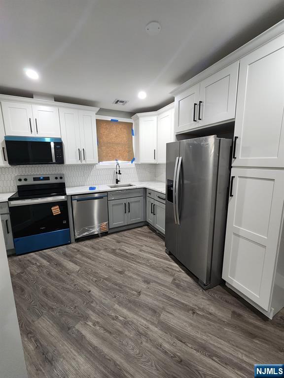 93 Hughes Street, Unit 2 Maplewood, NJ 07040 - Photo 6 of 16 a kitchen with stainless steel appliances granite countertop a refrigerator a stove and a sink