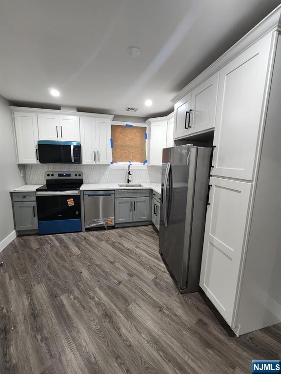 93 Hughes Street, Unit 2 Maplewood, NJ 07040 - Photo 7 of 16 a kitchen with stainless steel appliances a refrigerator sink and microwave