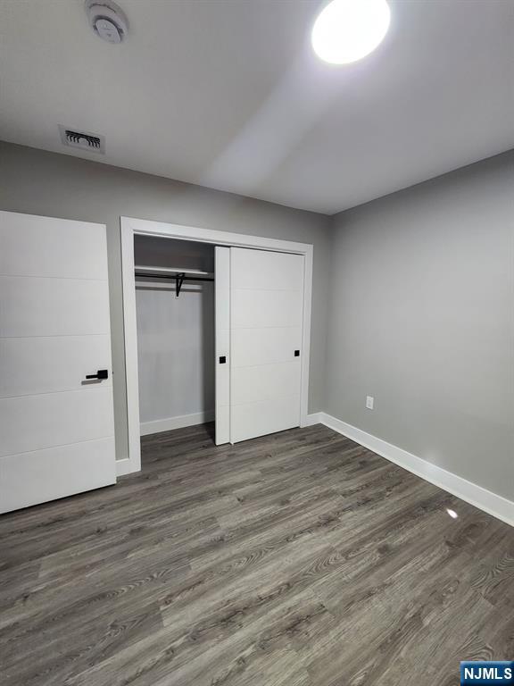 93 Hughes Street, Unit 2 Maplewood, NJ 07040 - Photo 8 of 16 a view of an empty room with wooden floor