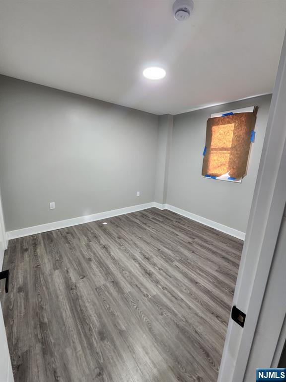 93 Hughes Street, Unit 2 Maplewood, NJ 07040 - Photo 10 of 16 wooden floor in an empty room with a window