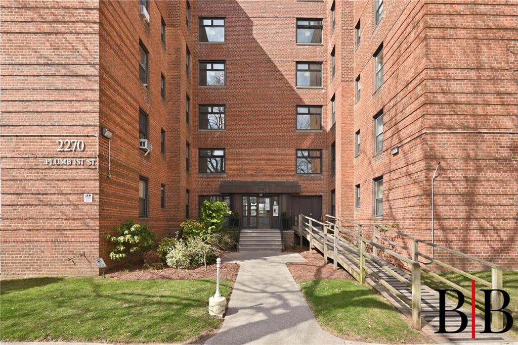2270 Plumb 1 Street, Unit 2D Brooklyn, NY 11229 - Photo 1 of 13 a view of a brick building next to a yard