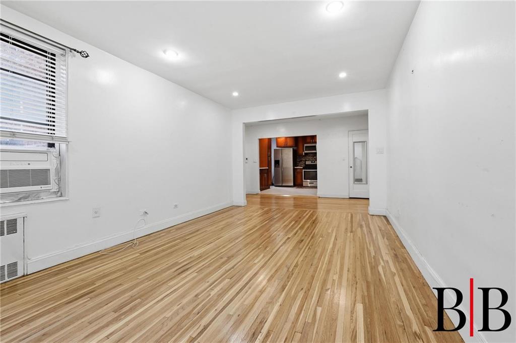 2270 Plumb 1 Street, Unit 2D Brooklyn, NY 11229 - Photo 3 of 13 a view of an empty room with wooden floor and a window