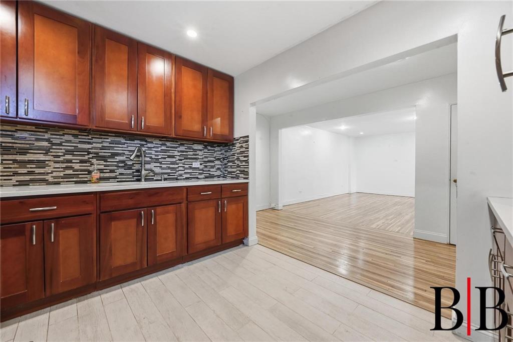 2270 Plumb 1 Street, Unit 2D Brooklyn, NY 11229 - Photo 5 of 13 a view of kitchen with granite countertop wooden cabinets
