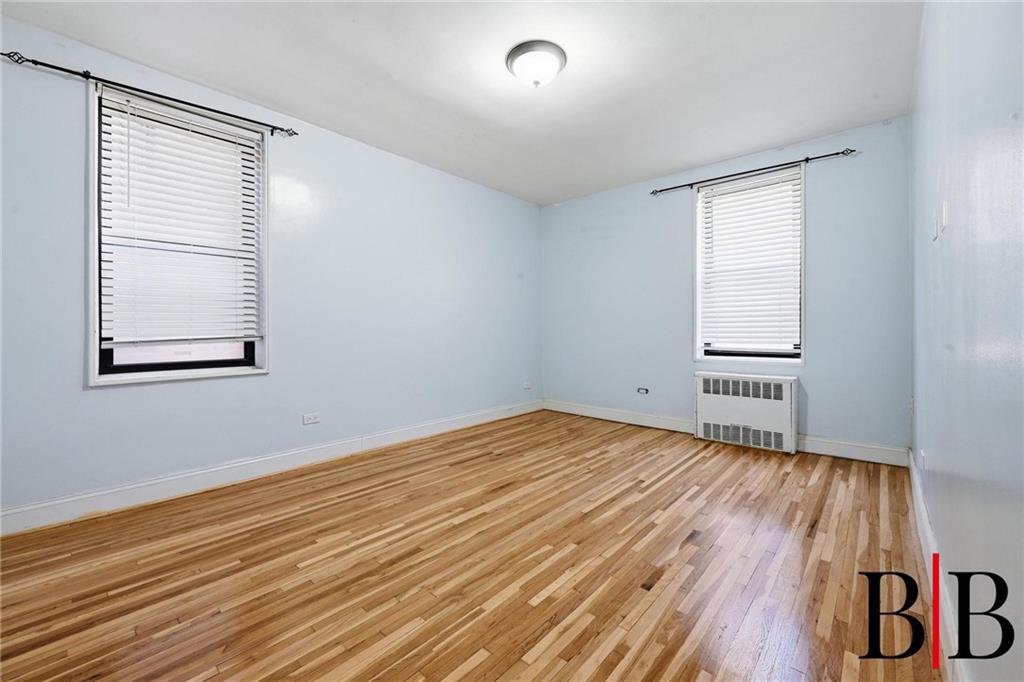 2270 Plumb 1 Street, Unit 2D Brooklyn, NY 11229 - Photo 6 of 13 a view of an empty room with wooden floor and a window