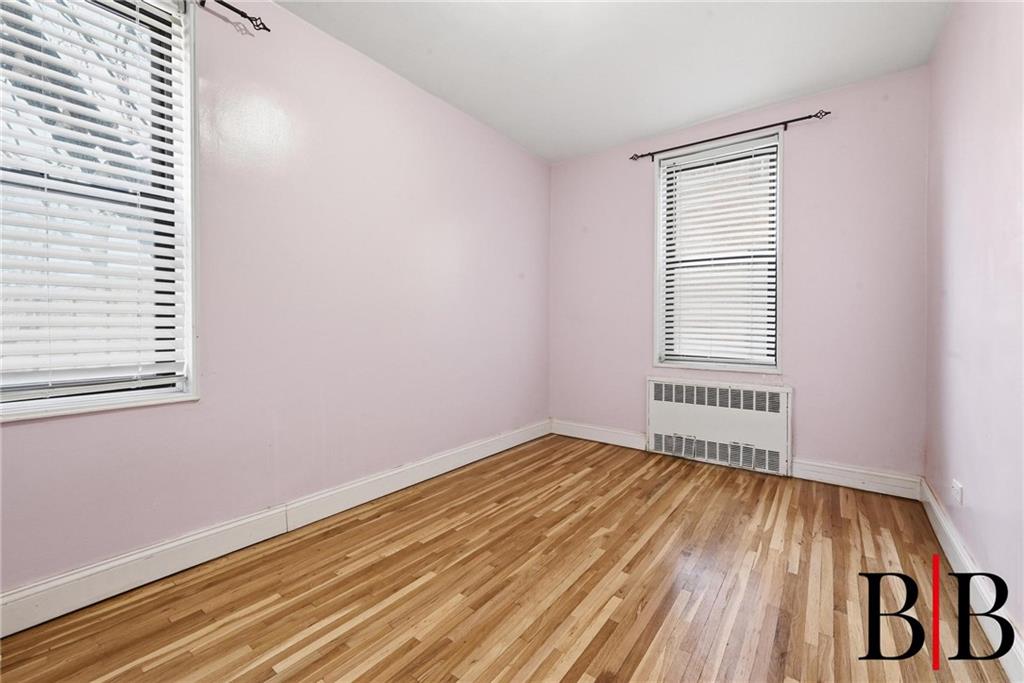 2270 Plumb 1 Street, Unit 2D Brooklyn, NY 11229 - Photo 8 of 13 a view of an empty room with wooden floor and a window