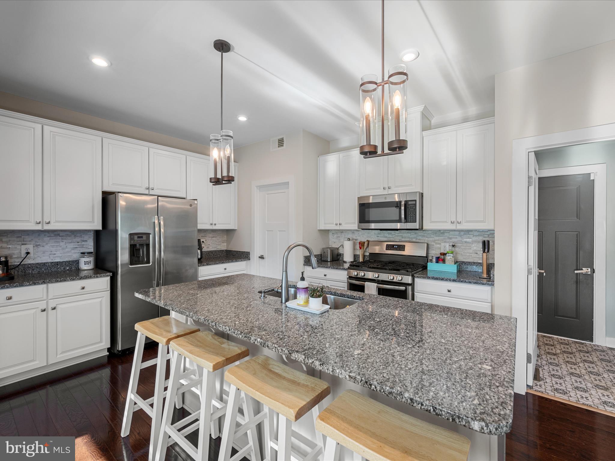 124 Emperor Drive White Post, VA 22663 - Photo 4 of 28 a kitchen with stainless steel appliances granite countertop a sink refrigerator and microwave
