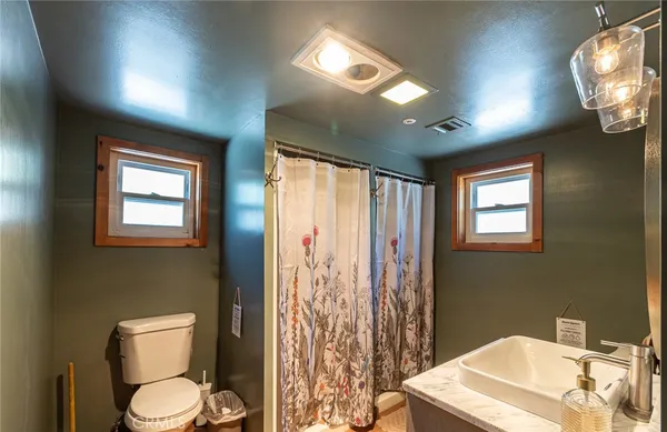 a bathroom with a sink a mirror and a toilet