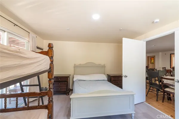 a bedroom with a bed and a dresser next to it