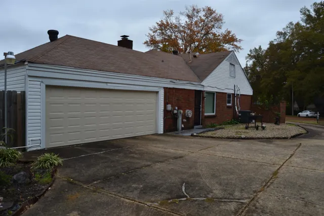 a backyard of a house with table and chairs