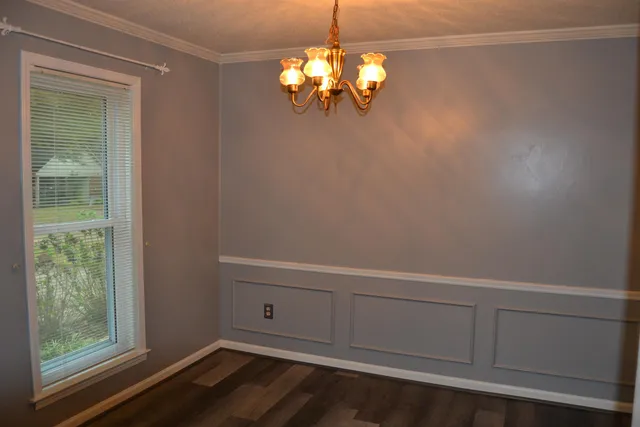 a view of a small space with wooden floor cabinets and a window