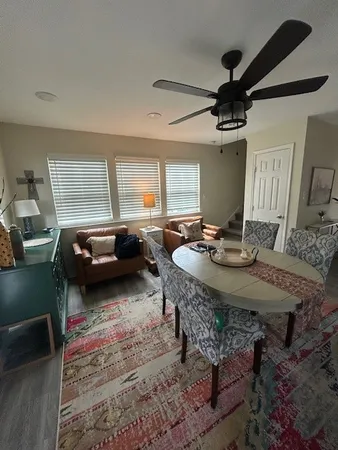 a living room with furniture and a wooden floor