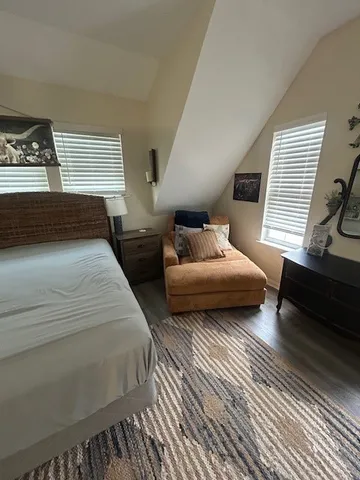 a bedroom with double bed and a couch