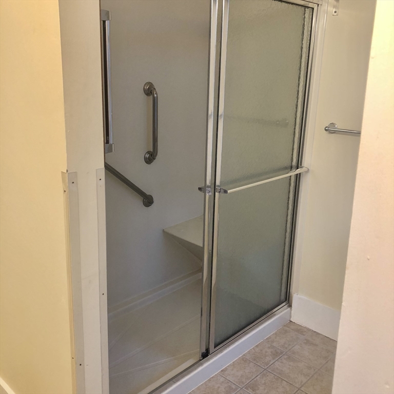 27 High Street, Unit 1 Clinton, MA 01510 - Photo 14 of 30 a bathroom with a glass shower door