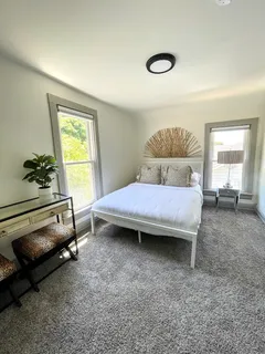 a bedroom with a bed and a window