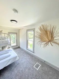 a spacious bedroom with a bed and a large window