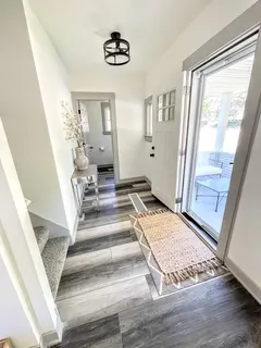 a view of an entryway with wooden floor and a livingroom