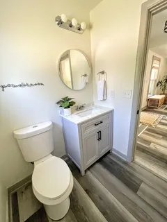 a bathroom with a toilet a sink and mirror