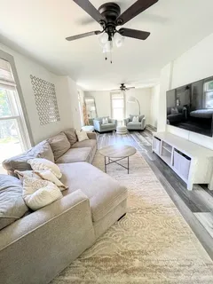 a living room with furniture and a flat screen tv