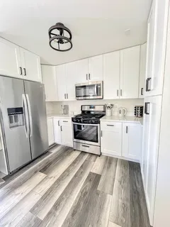 a kitchen with stainless steel appliances a refrigerator a stove a sink dishwasher and a refrigerator