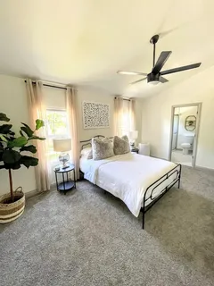 a bedroom with a bed and ceiling fan