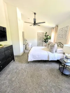 a bedroom with a bed and a television