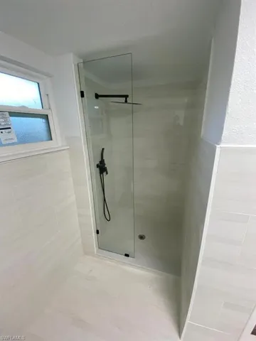 a bathroom with a glass shower door