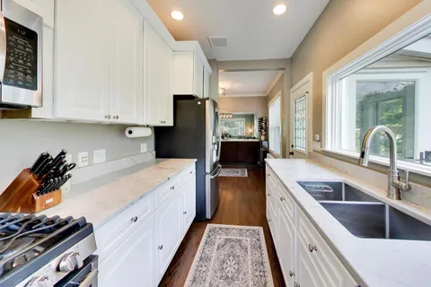 a kitchen with a sink and a stove top oven