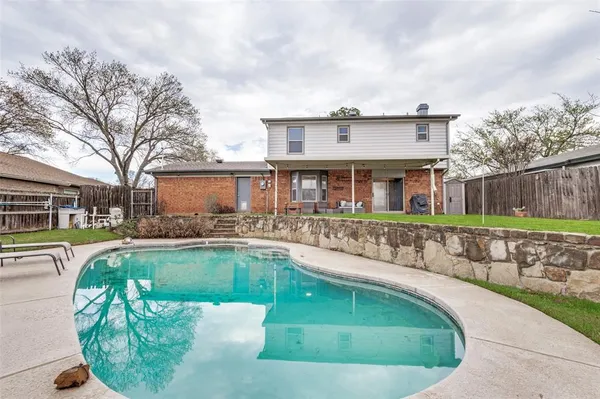 a view of a house with swimming pool and sitting area