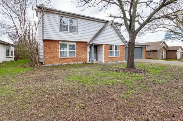 a front view of house with yard and trees
