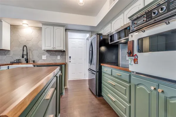 a kitchen with a refrigerator and a microwave