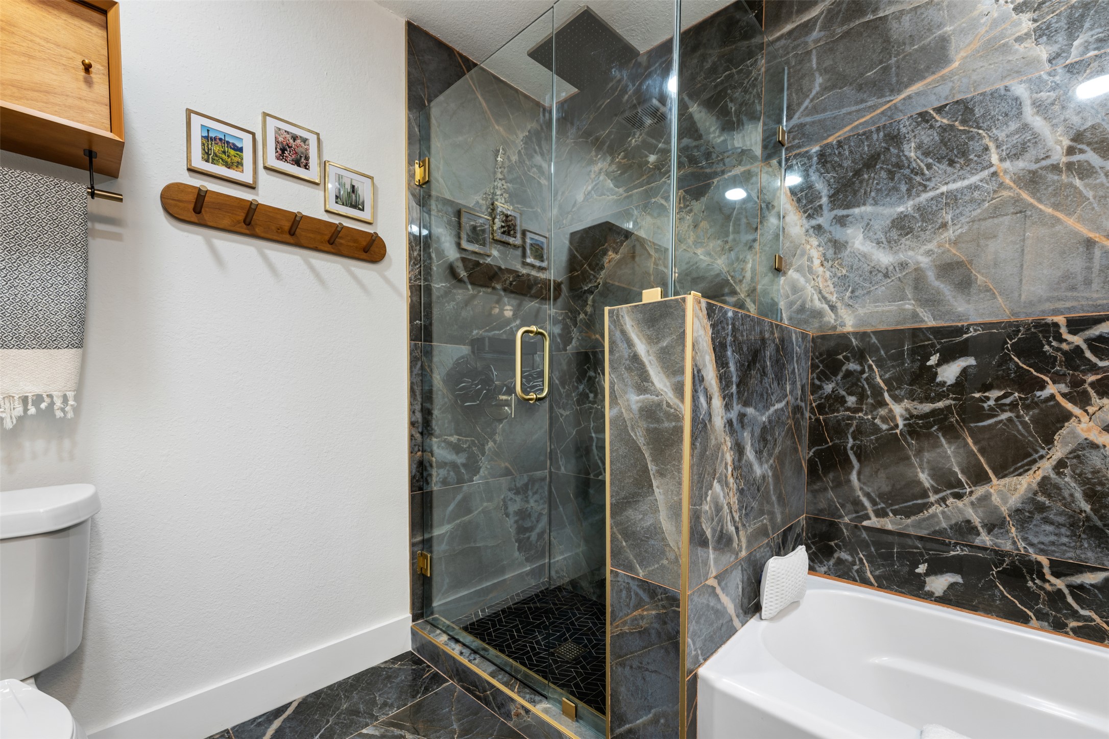 1616 Webberville Road, Unit A Austin, TX 78721 - Photo 19 of 35 Bathroom featuring a garden tub, dark marble finish floors, and a marble finish shower